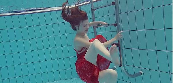  Red Dressed teen swimming with her eyes opened